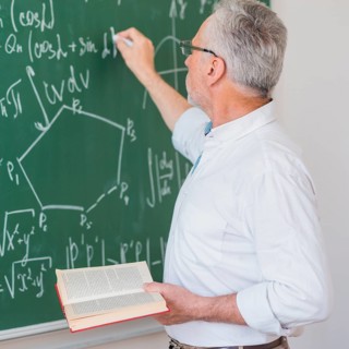 Serious lecturer glasses chalking formula blackboard