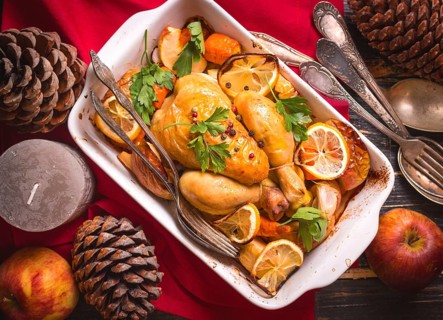 Roasted chicken. Christmas food. Rustic celebration table with roasted chicken, vegetables, apples,
