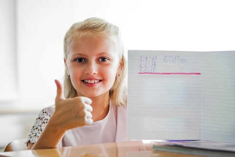 Girl sitting school table with notebook