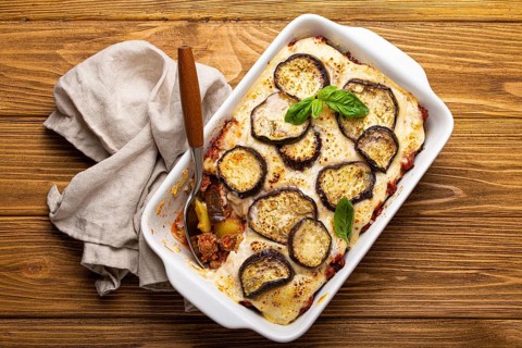 Greek mediterranean dish Moussaka with baked eggplants, ground beef in white ceramic casserole with