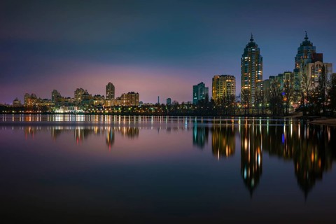 Night view of modern buildings in the Obolon district of Kiev, Ukraine, close to the Dnieper River,