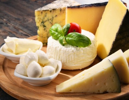 Different sorts of cheese on kitchen table