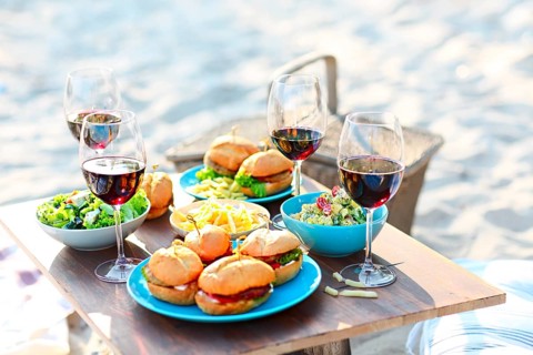 Beach summer picnic table with red wine glasses