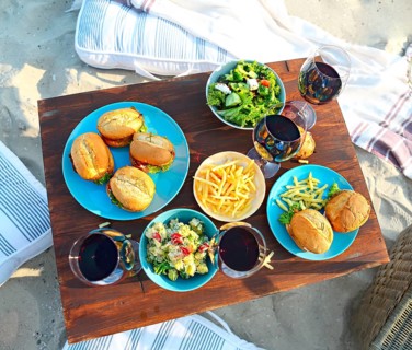 Beach summer picnic table with red wine glasses