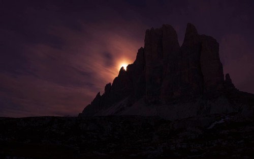 Setting full moon on the edge of the smaller Three Peaks, Hochpustertal valley, Sexten, South Tyrol