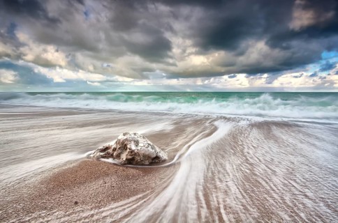 Clouded sky and ocean waves with long exposure, Etretat, France, Europe
