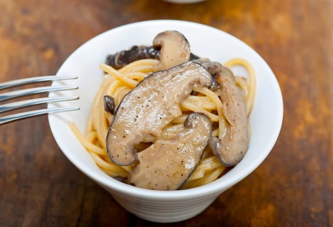 Italian spaghetti pasta and fresh wild mushrooms on rustic wood table