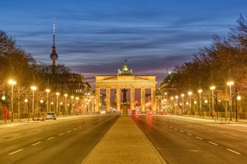 The famous Brandenburg Gate in Berlin with the TV tower at dusk
