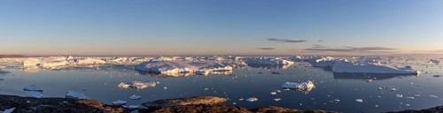 Ilulissat, Greenland, July 7, 2018: Panoramic view of the Ilulissat Icefjord during midnight sun.