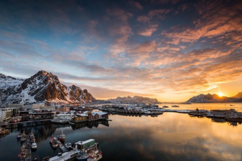View over the port of Svolvaer on the Lofoten islands in colorful early morning sunrise in winter