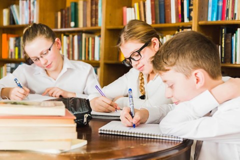 Cute children studying school library