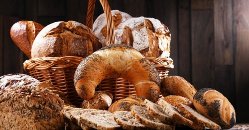 Assorted bakery products including loafs of bread and rolls