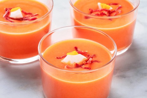 Salmorejo, Spanish cold tomato and bread soup, in glasses on a marble background, close-up shot