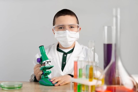 Boy laboratory with microscope