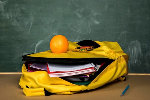 Yellow knapsack with copybooks orange