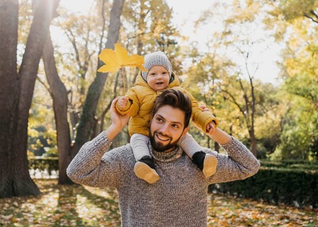 Smiley dad with his baby outside nature