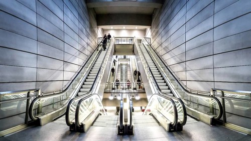 Copenhagen, Denmark, January 20, 2017: People on escalators at Forum metro station, Europe
