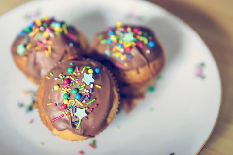 Homemade sweet cupcakes on a plate with colourful decoration