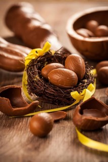 Assorted chocolate eggs for Easter on wooden background