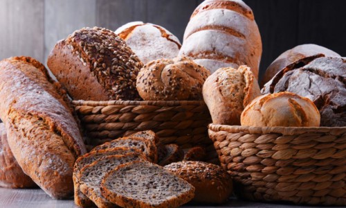 Composition with assorted bakery products in wicker basket