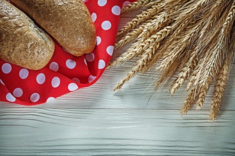 French bread wheat ears red napkin on white board