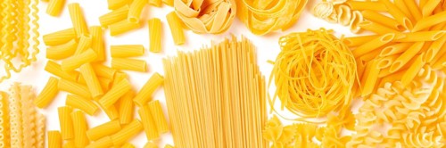 Italian pasta texture panoramic flatlay banner, overhead shot on a white background. Fusilli,