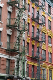 Colourful fire escape on the rustically decorated building facade, Manhattan, New York City, New