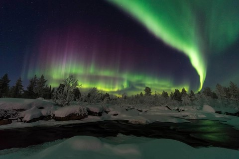 Northern Lights (Aurora borealis) over a moonlit winter landscape, Norrbotten, Lapland, Sweden,