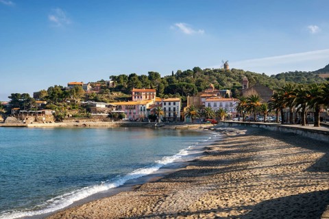 Collioure view from the beach with the Mill on the top of the village
