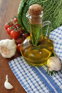 Vegetables still life with olive oil, mushrooms on wooden background