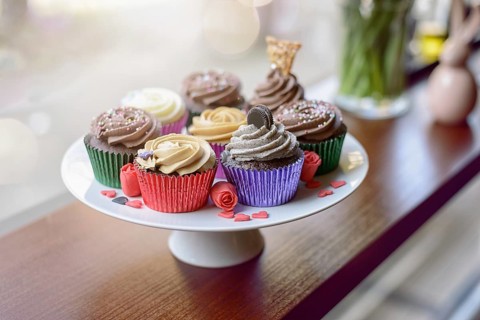 Eight deliciously sweet cupcakes covered with creamed chocolate, vanilla and various other
