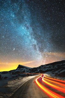 Night landscape. Night sky with a north hemisphere Milky Way and stars. The night road illuminated