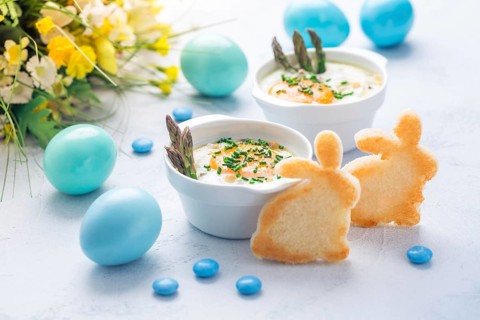 Shirred eggs (Oeuf cocotte) or baked eggs with green asparagus with Easter toast bunny and eggs