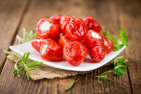 Fresh made Red Pepper (stuffed with cheese) on an old and rustic wooden table (selective focus,