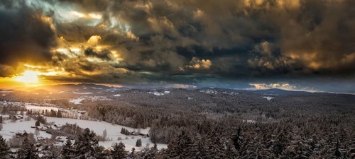 Sunset over the snowy winter landscape near Neuschönau, Bavaria, Germany, Europe