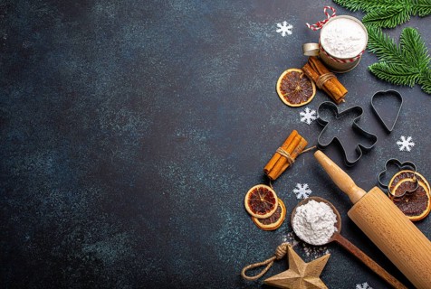 Christmas and New Year festive baking background with kitchen tools, flour, fir tree branch, metal
