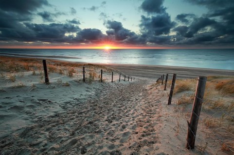 Sand path to North sea beach at sunset, Netherlands