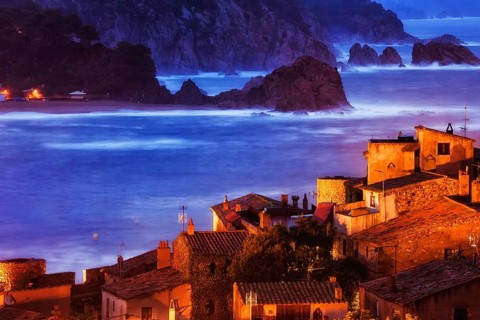 Old coastal town of Tossa de Mar at dusk on Mediterranean Sea, view over historic houses of Vila