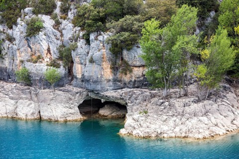 Cave on the rocky shore of Lac de Sainte-Croix, near dam, Provence-Alpes-Côte d'Azur, Provence,
