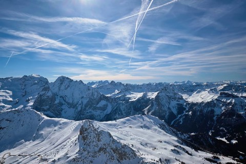 View of a ski resort piste and Dolomites mountains in Italy from Passo Pordoi pass. Arabba, Italy,