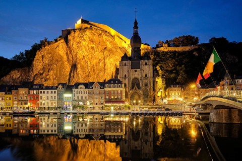 Night view of Dinant town, Collegiate Church of Notre Dame de Dinant over River Meuse and Pont