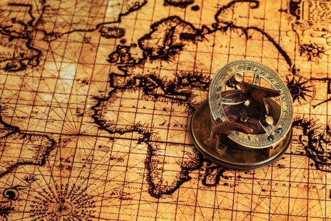 Travel geography navigation concept background, old vintage retro compass with sundial on ancient