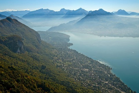 View from the summit of Mont Baron over the village of Veyrier-du-Lac to Lac dAnnecy in autumn mist