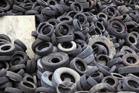 Old car tyres lie on stockpiles for recycling