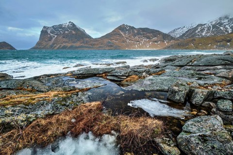 Rocky coast of fjord of Norwegian sea in winter. Lofoten islands, Norway, Europe