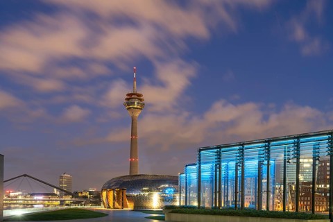 Terrace of the Hyatt Hotel and the Rhine Tower in Düsseldorf at dusk, North Rhine-Westphalia,