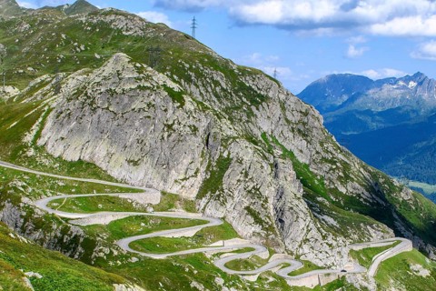 Steep mountain slope in the Gotthard massif, in the foreground serpentines hairpin bends winding