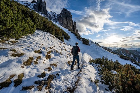 Hikers on a hiking trail with snow, ascent to Kramerspitz, in autumn, Ammergau Alps, Bavarian