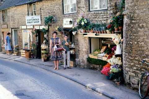 Stow on the Wold, Gloucestershire, England 1963 Woman and boy posing in front of a fruit shop in