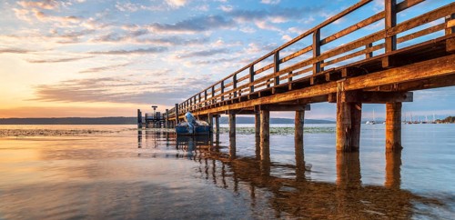 Morning atmosphere at the Lake Ammer, jetty in the first morning light, near Riederau, Bavaria,